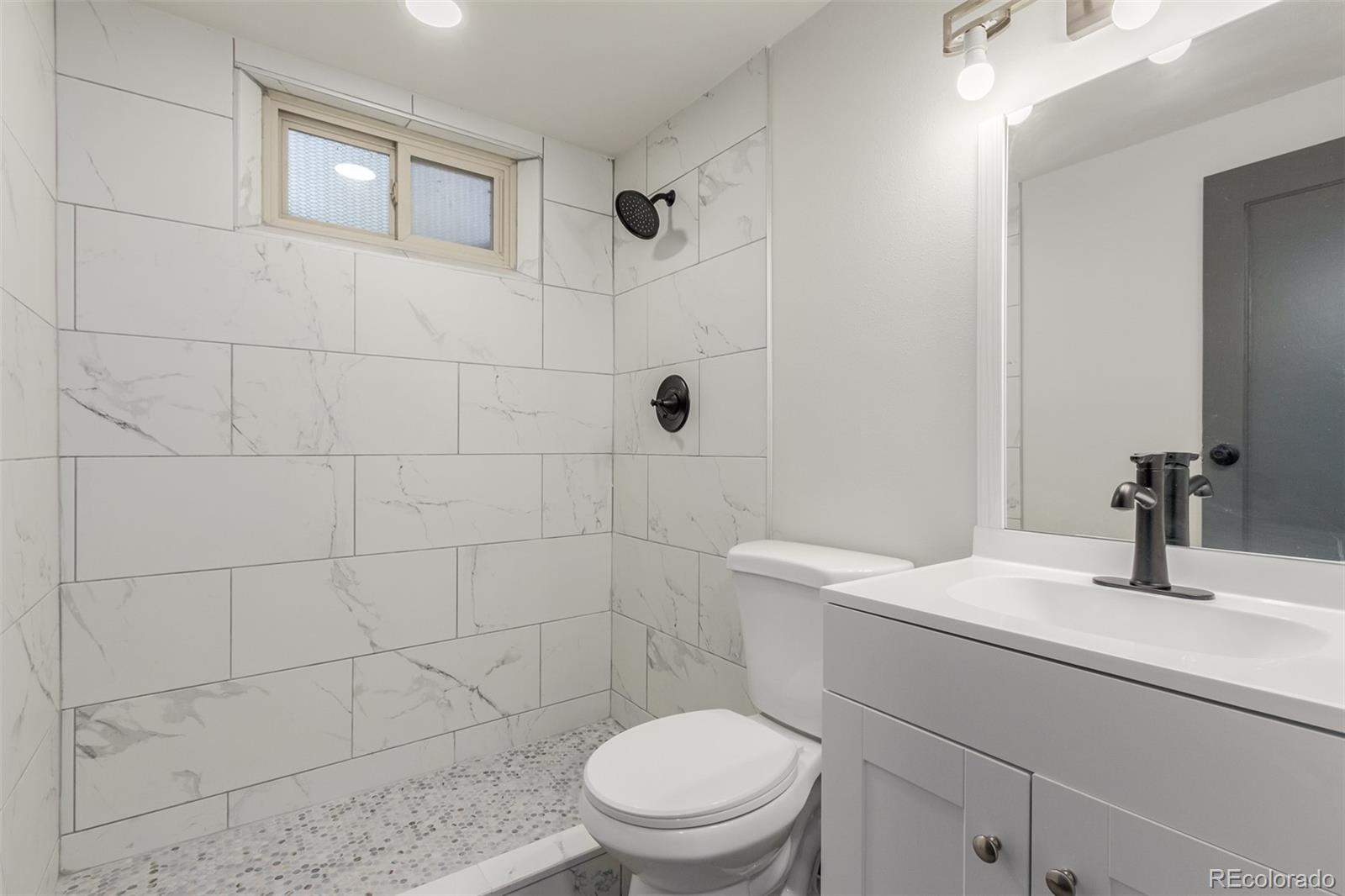 7330 Decatur Street Westminster, CO 80030 - Photo 31 of 37 a bathroom with a sink a toilet and shower