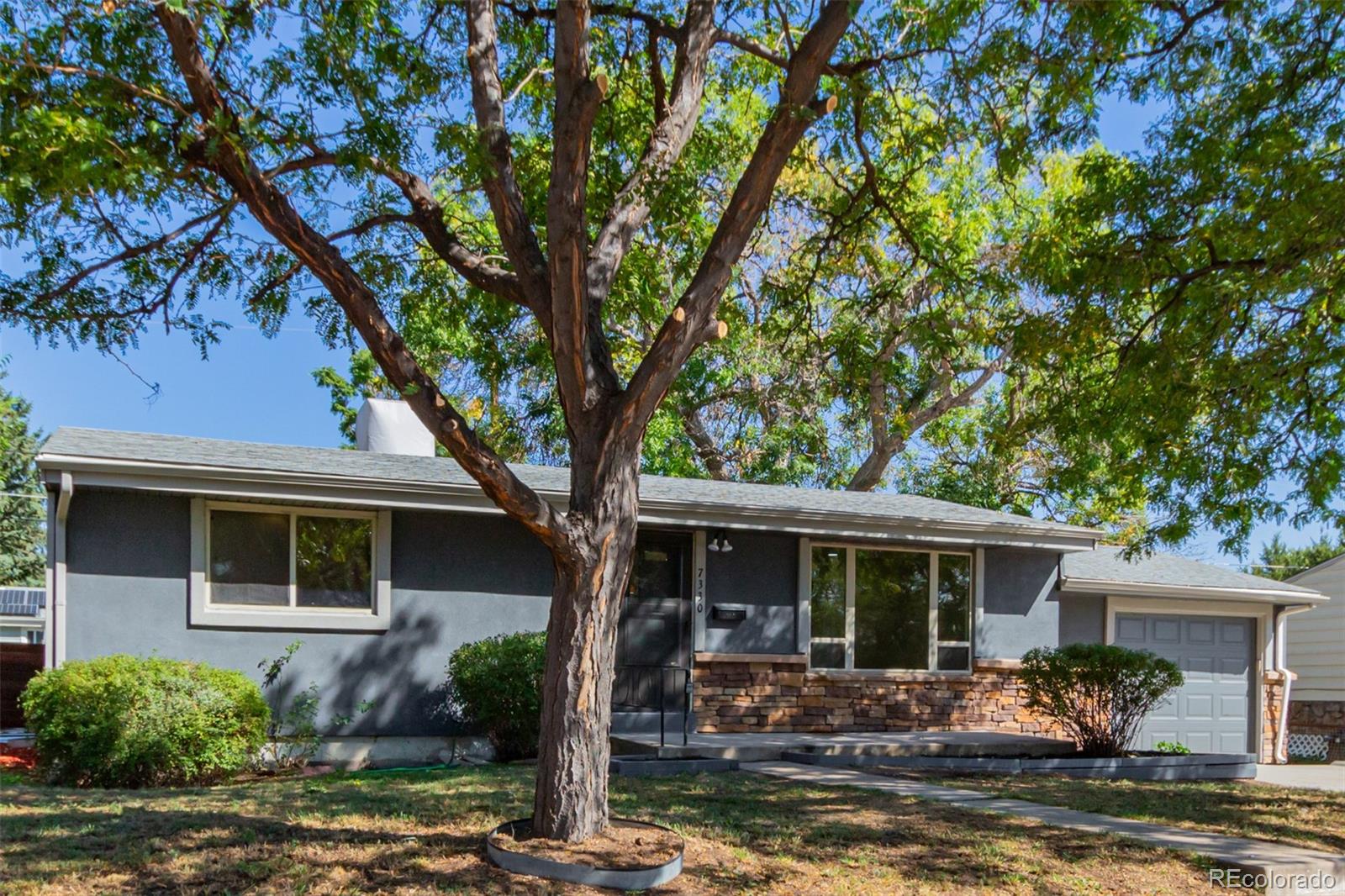 7330 Decatur Street Westminster, CO 80030 - Photo 4 of 37 a front view of a house with garden