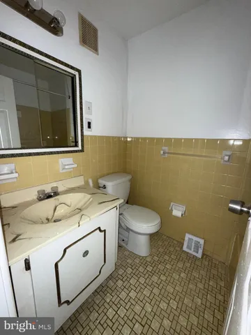 a bathroom with a sink toilet and mirror