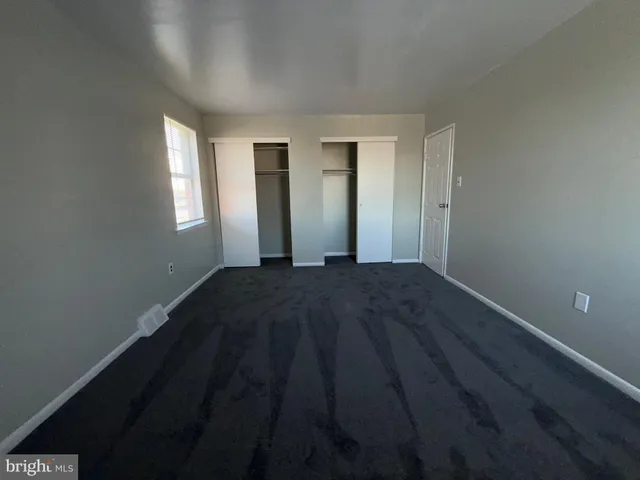a view of a livingroom with wooden floor and a window
