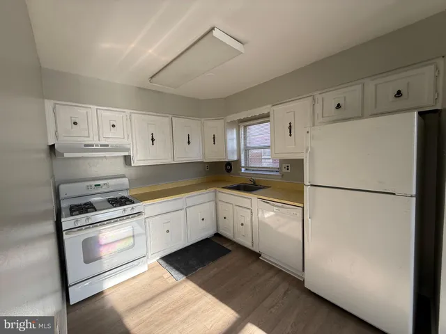 a kitchen with cabinets stainless steel appliances and a counter space