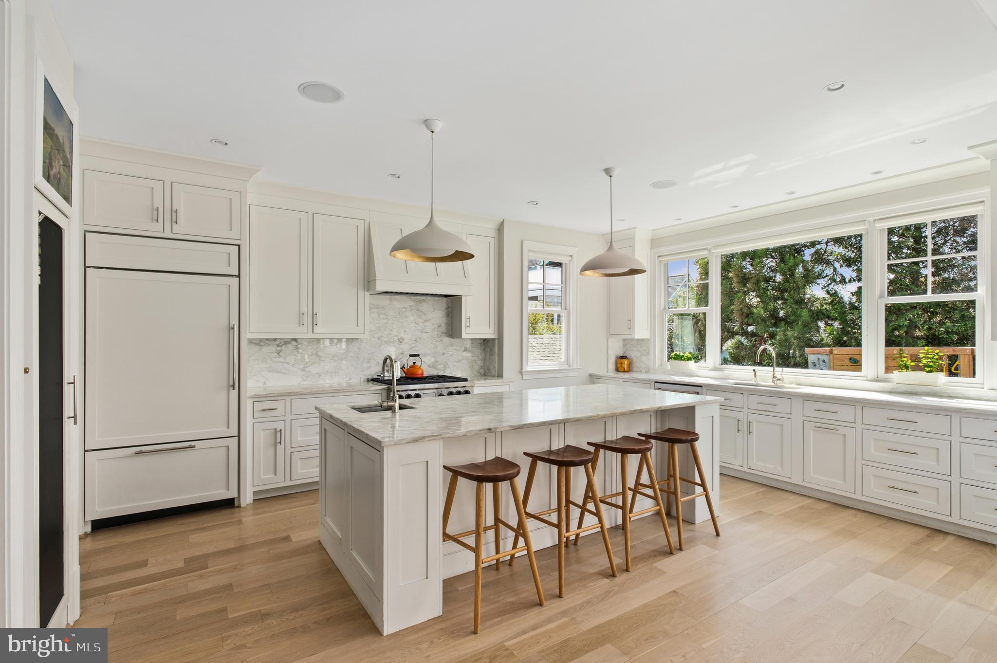 3312 Lowell Street Northwest Washington, DC 20008 - Photo 2 of 44 a kitchen with stainless steel appliances granite countertop a stove a sink a refrigerator and white cabinets with wooden floor