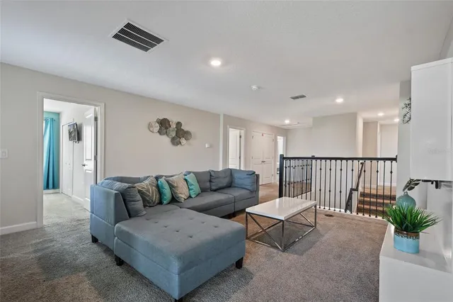 a living room with furniture and a potted plant