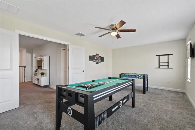 a room with furniture and pool table
