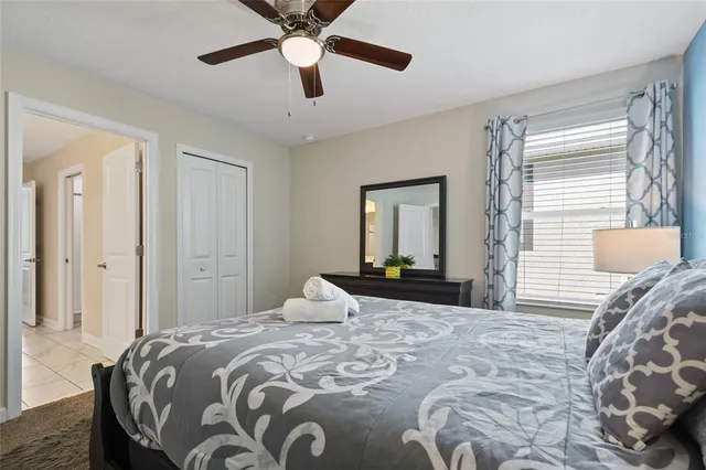 a bedroom with a bed and a painting on the wall