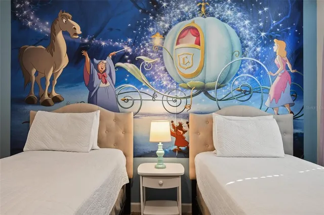 a bedroom with a bed and a chandelier