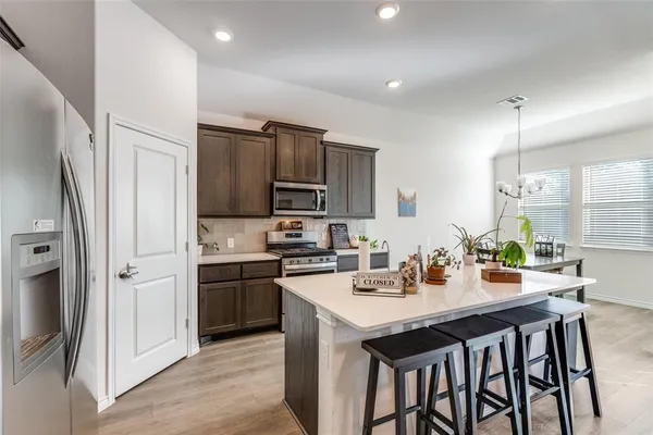 a kitchen with granite countertop a sink appliances and cabinets