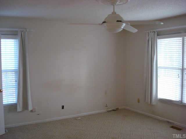 3605 Old Country Lane Raleigh, NC 27616 - Photo 5 of 10 First floor master bedroom with berber carpet, remote control ceiling fan and walk-in closet with built in shelving.