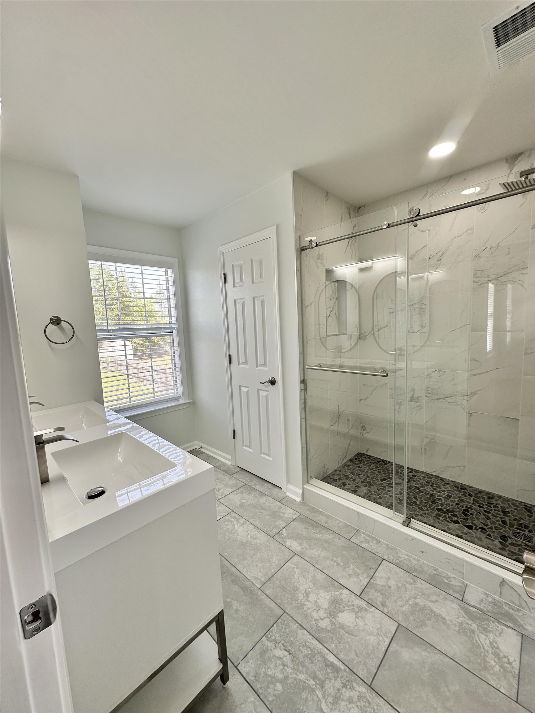 10006 Cameron Ridge Trail Memphis, TN 38016 - Photo 18 of 29 a bathroom with a shower sink and mirror