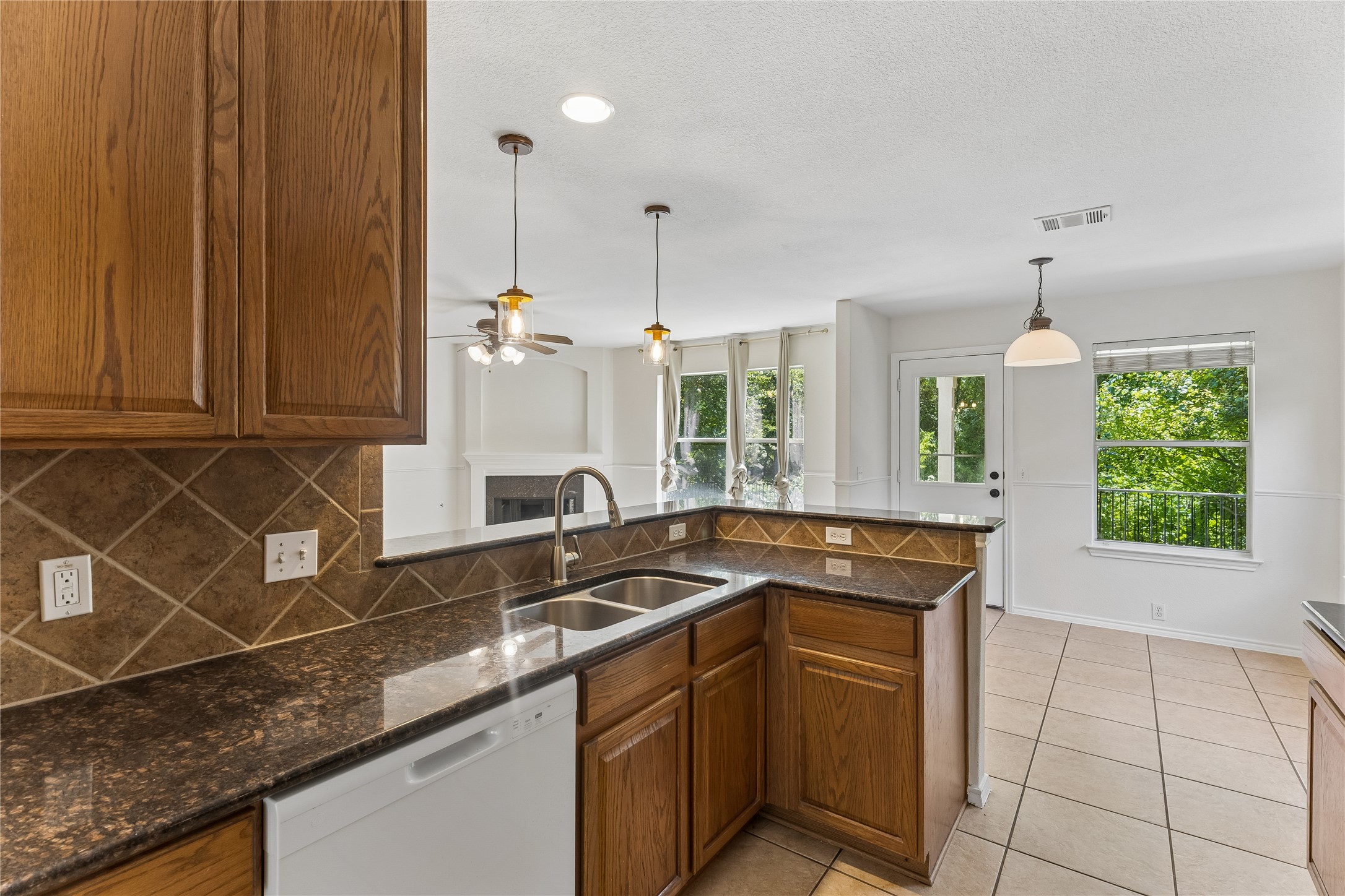 2372 Paradise Ridge Drive Round Rock, TX 78665 - Photo 8 of 40 A well-appointed kitchen features rich cabinetry, granite counters, and a seamless flow into the living area.