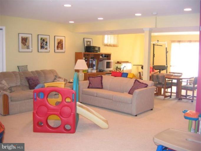14504 Bubbling Spring Road Boyds, MD 20841 - Photo 11 of 21 a living room with furniture and a floor to ceiling window
