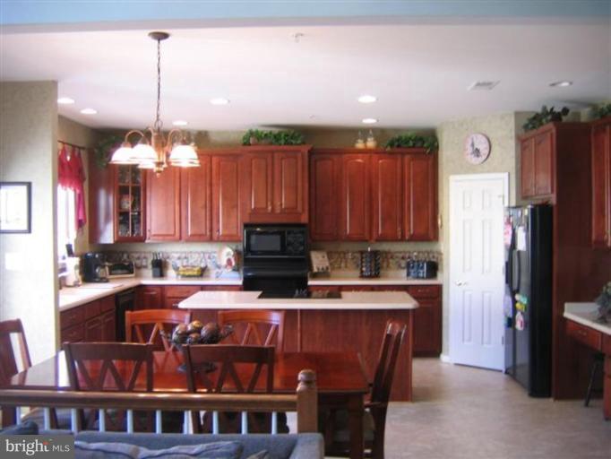 14504 Bubbling Spring Road Boyds, MD 20841 - Photo 14 of 21 a kitchen with kitchen island granite countertop a sink a counter top space appliances and cabinets
