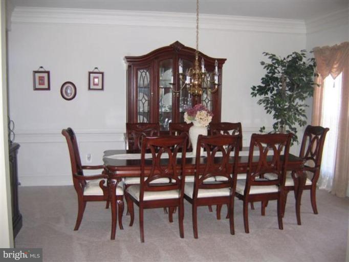14504 Bubbling Spring Road Boyds, MD 20841 - Photo 19 of 21 a view of a dining room with furniture and chandelier