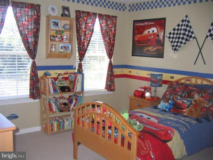 14504 Bubbling Spring Road Boyds, MD 20841 - Photo 20 of 21 a bedroom with furniture and paintings on the wall