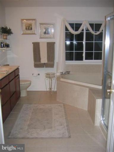 14504 Bubbling Spring Road Boyds, MD 20841 - Photo 5 of 21 a bathroom with a bathtub sink and toilet