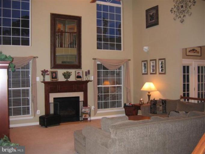 14504 Bubbling Spring Road Boyds, MD 20841 - Photo 8 of 21 a living room with furniture a fireplace and a window