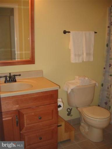 14504 Bubbling Spring Road Boyds, MD 20841 - Photo 10 of 21 a bathroom with a toilet a sink and mirror