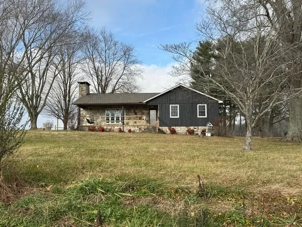 a front view of house with trees