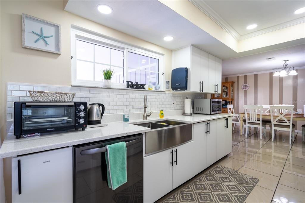 2140 Pinehurst Street Sarasota, FL 34231 - Photo 11 of 40 a kitchen with lots of counter top space and dining table