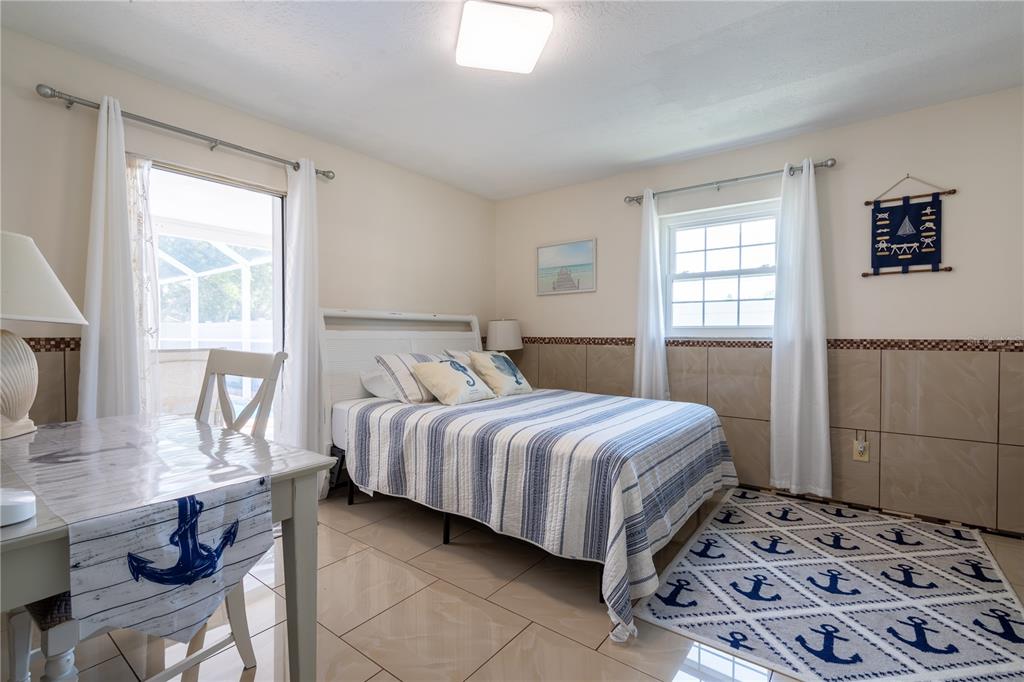 2140 Pinehurst Street Sarasota, FL 34231 - Photo 12 of 40 a bedroom with a bed and wooden floor