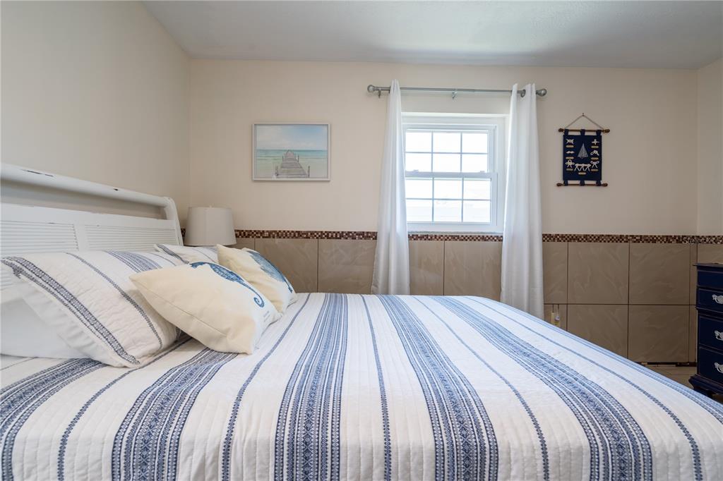 2140 Pinehurst Street Sarasota, FL 34231 - Photo 13 of 40 a bedroom with a bed and a window