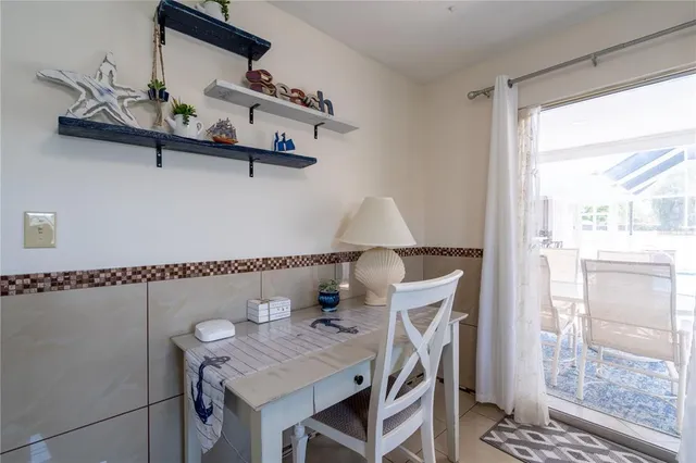 a view of a workspace with furniture and window