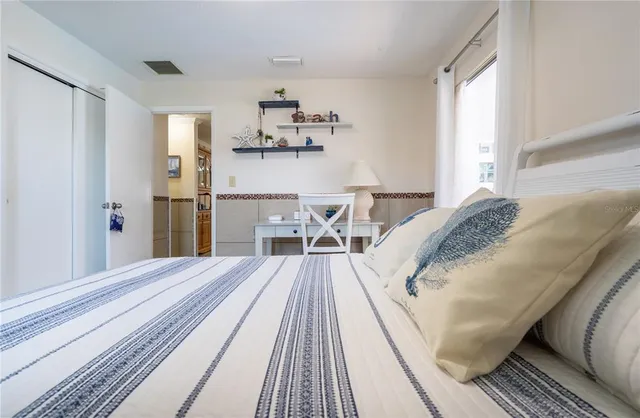 a view of a bedroom with wooden floor and bed