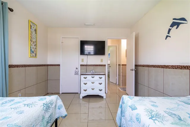 a bedroom with a bed and a television