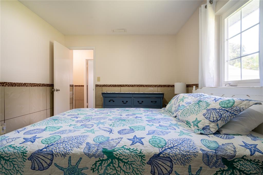 2140 Pinehurst Street Sarasota, FL 34231 - Photo 21 of 40 a bedroom with a large bed and a window