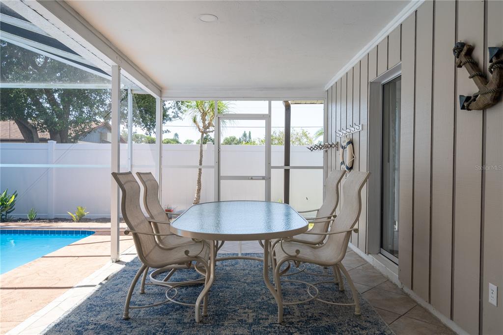 2140 Pinehurst Street Sarasota, FL 34231 - Photo 24 of 40 a view of a dining room with furniture wooden floor and a potted plant