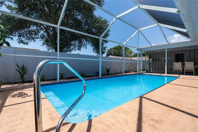 a view of a backyard with swimming pool