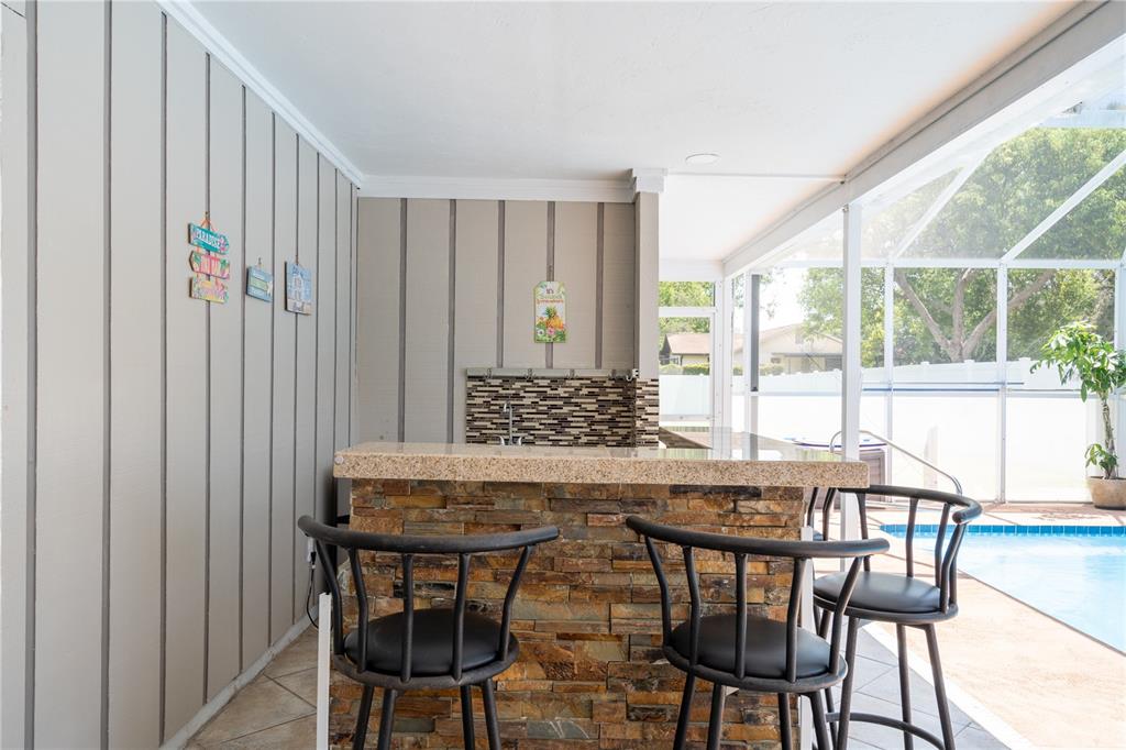 2140 Pinehurst Street Sarasota, FL 34231 - Photo 29 of 40 a view of a dining room with furniture and wooden floor