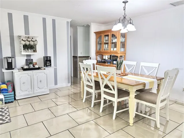 a view of a dining room with furniture and chandelier