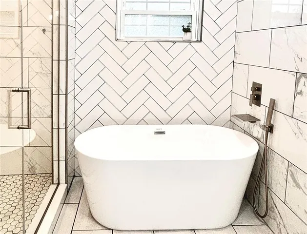 a white bath tub sitting in a bathroom