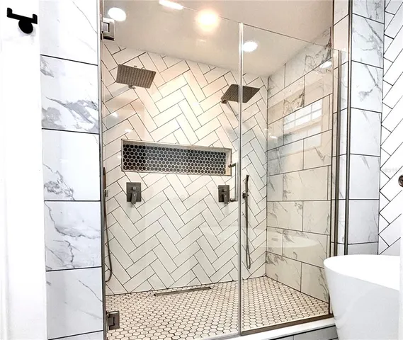 a bathroom with a bathtub and shower