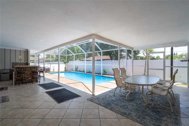 a dining room with furniture and a floor to ceiling window