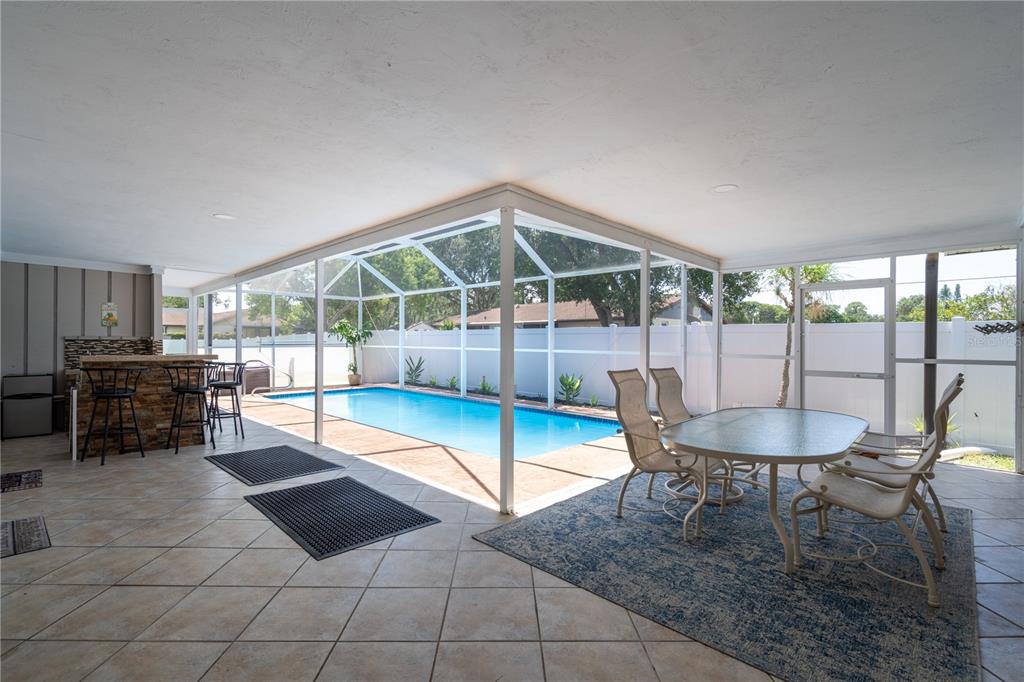 2140 Pinehurst Street Sarasota, FL 34231 - Photo 40 of 40 a dining room with furniture and a floor to ceiling window