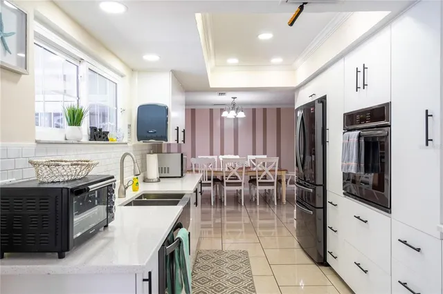 a kitchen with stainless steel appliances kitchen island granite countertop a stove and a sink