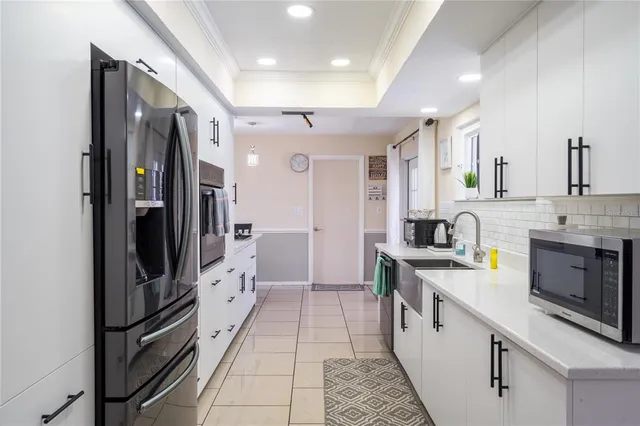 a large kitchen with a large window and stainless steel appliances