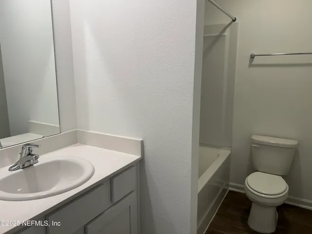 a bathroom with a sink toilet and a mirror