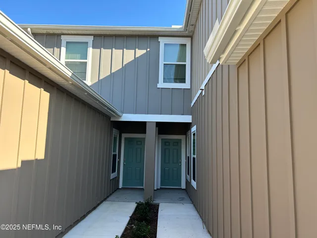 a view of a house and wooden deck