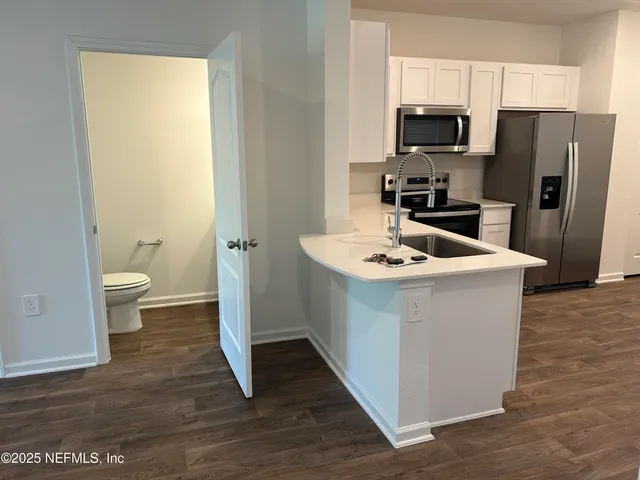 a kitchen with stainless steel appliances a refrigerator sink and stove