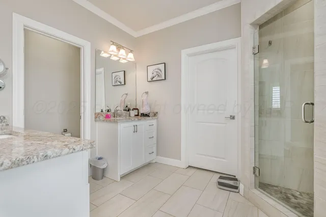 a bathroom with a granite countertop sink mirror and shower