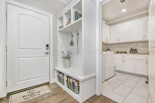 a kitchen with white cabinets and white appliances