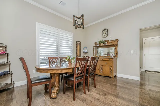 a dining room with furniture window and wooden floor