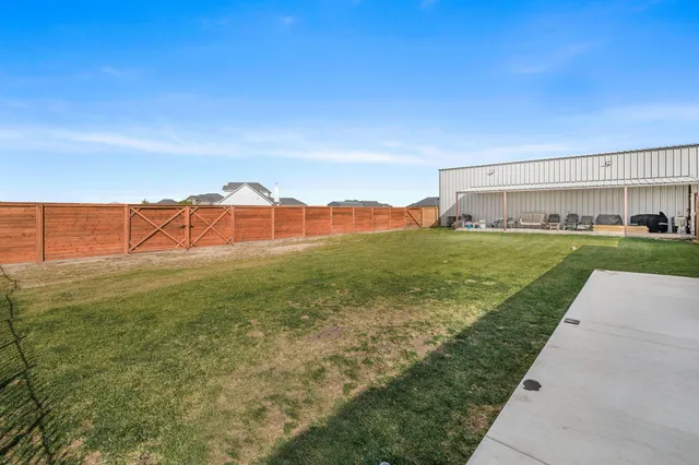 a view of a garden with a building in the background