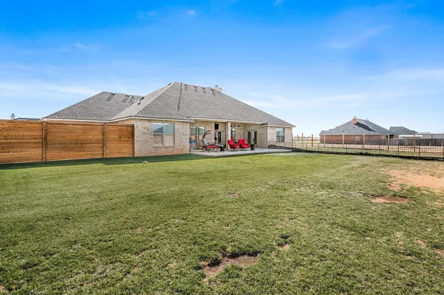 a view of a house with a yard and sitting area