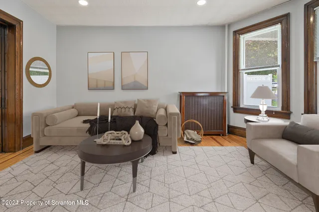 a living room with furniture a window and a table