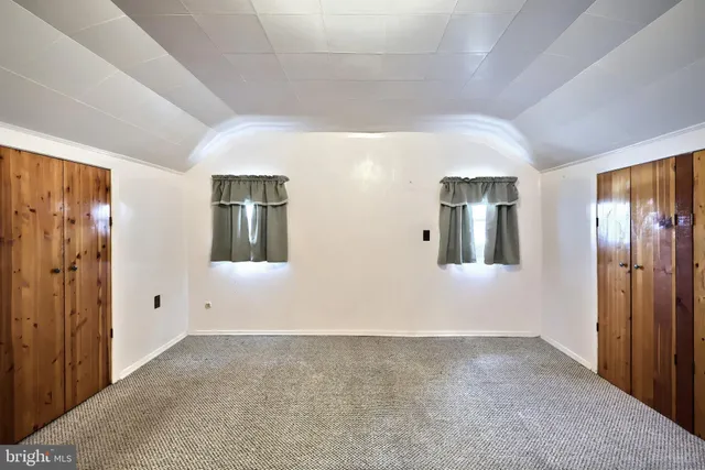 a bathroom with a tub a sink and a mirror