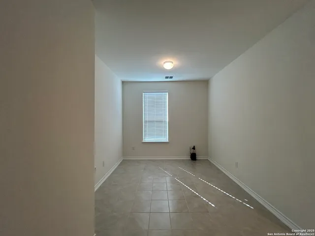 a view of an empty room and windows